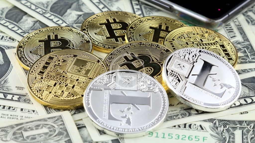 A collection of cryptocurrencies, including Bitcoin, Ethereum, and Litecoin, arranged on top of US currency, representing the intersection of digital currencies and traditional investments in an investment portfolio.