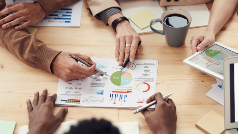A person analyzing investment charts, highlighting the benefits of investing in index funds for long-term financial growth and stability.